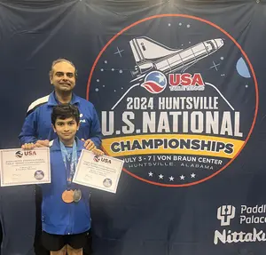Atharva after winning his first 2 medals with happy coach Shashin!